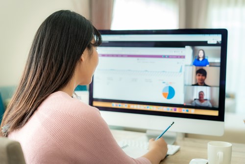 Woman attends an online meeting on her laptop