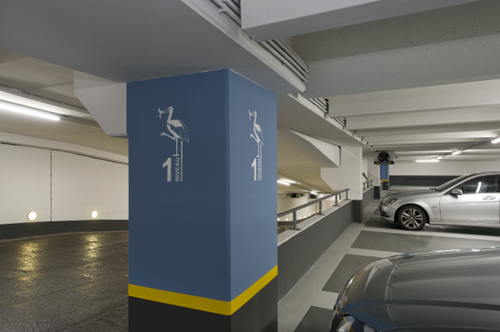 Blue column in parking garage with pictogram and number displayed