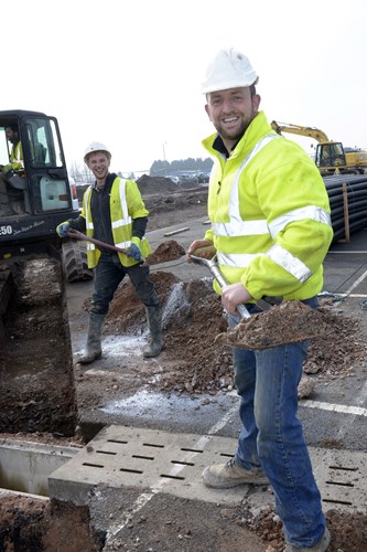 Front of pic – Dave Hodges from Groundworks company DHC Services  gets stuck in to the work with Dan Southall in the digger