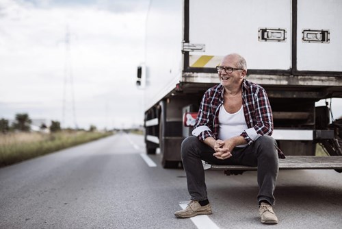 image of a truck driver sitting on the back of the truck