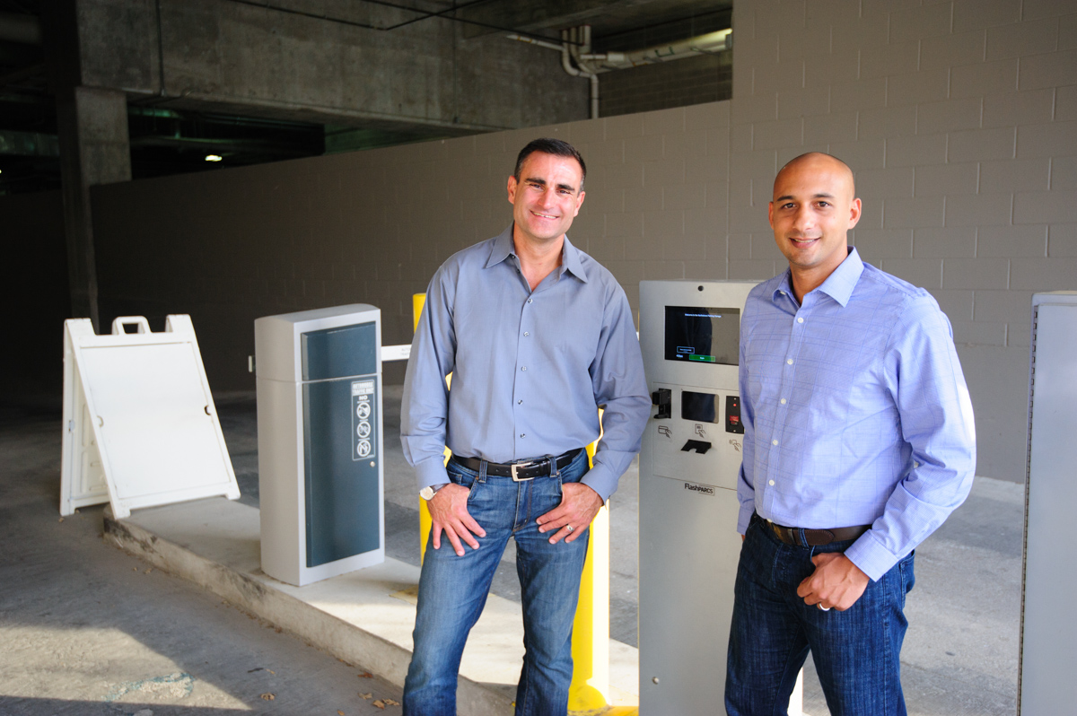 Pres. Sam Goodner and CEO Juan Rodriguez stand in-front of Klever Logic's garage parking solution