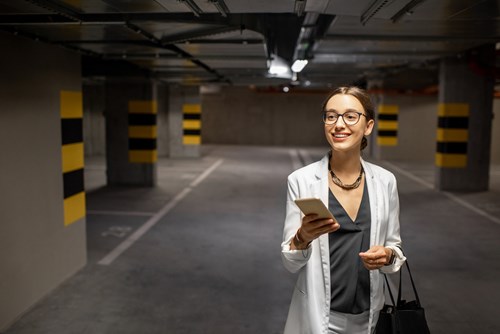 Woman in the underground parking looking at phone