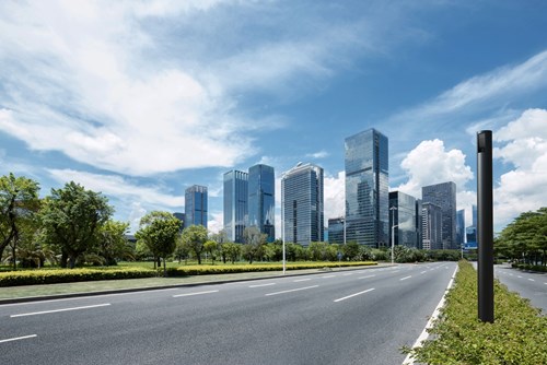 Cityscape in the background with road monitored by a city scanner column