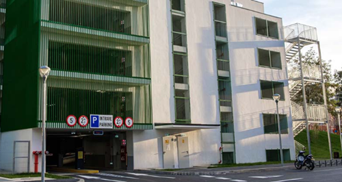 Entrance to the parking garage on the ground floor of a white building