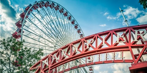 Ferris wheel behind Navy Pier sign